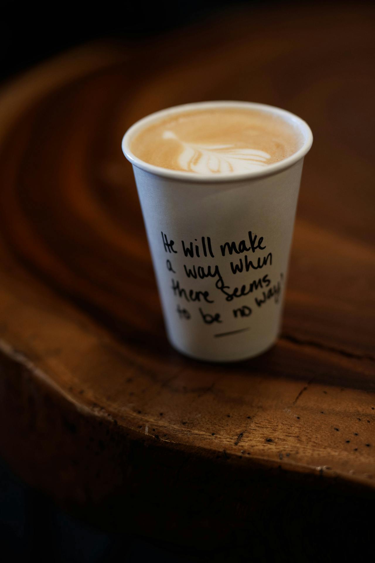 A coffee cup with a Bible verse printed on it, symbolizing warmth, faith, and connection.